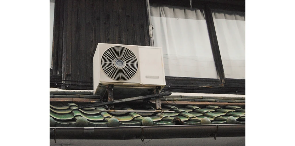 A heat pump outdoor unit on a roof