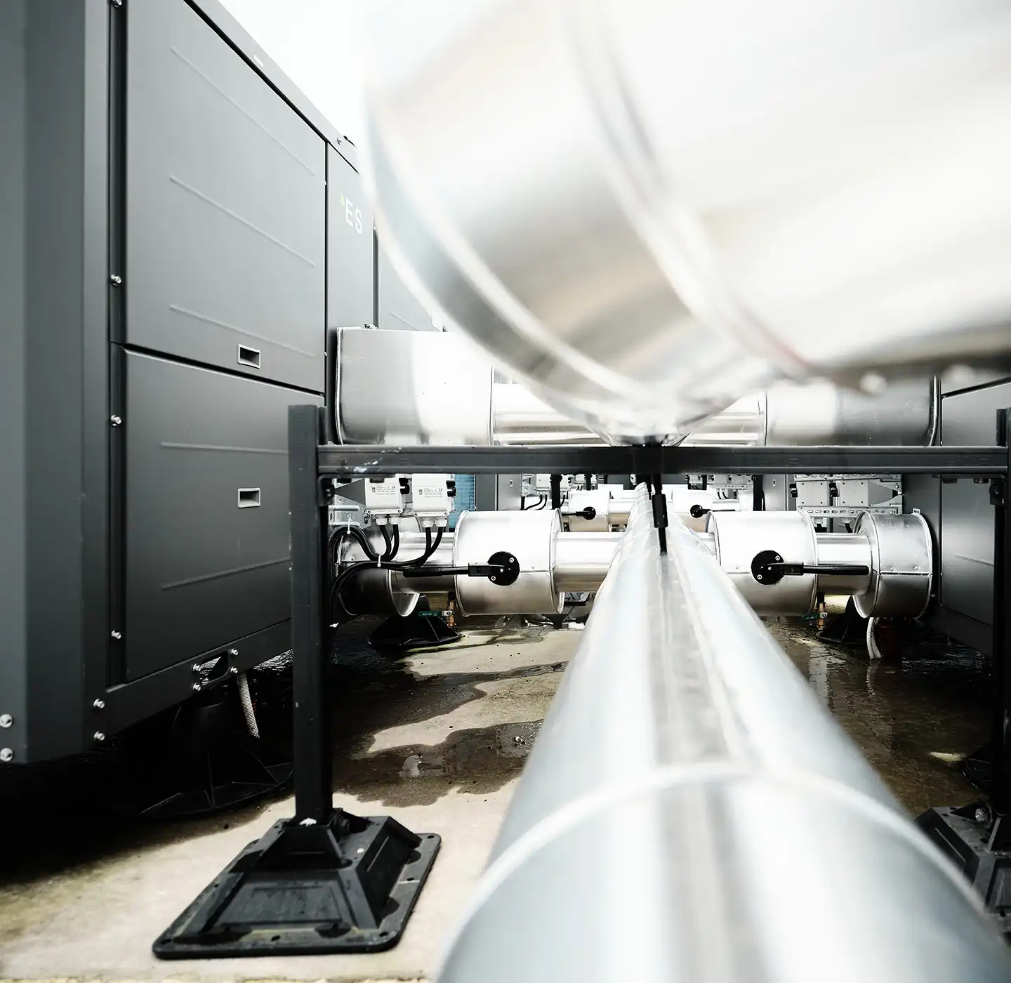 Close-up of commercial heat pump system with connected pipes and components.